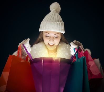 Young woman opening a bag full of Christmas magic
