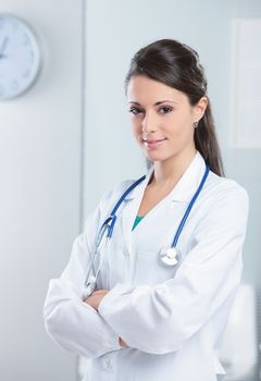 Portrait of a smiling woman doctor with her arms crossed