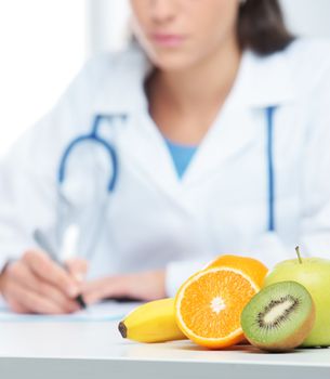 Nutritionist Doctor is writing a prescription. Focus on fruit