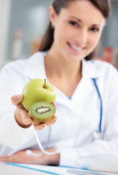 Nutritionist Doctor holding some fruits in her hand