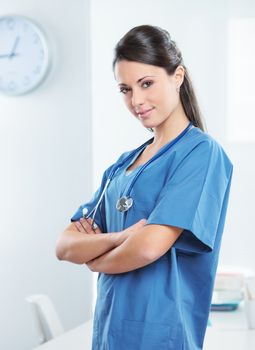 Portrait of a smiling woman doctor with her arms crossed