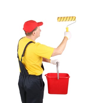 Worker in hardhat paints with bucket. Isolated on a white background.