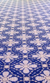 The blue background rug with a pattern in perspective