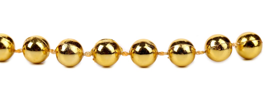 Decorative golden beads. Horisontal. Isolated on a white background.