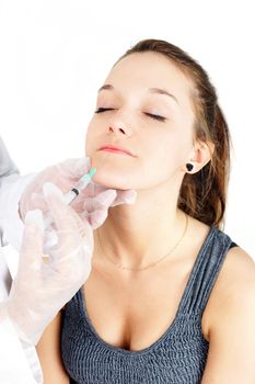 Beautiful young woman getting lip injection, botox or collagen