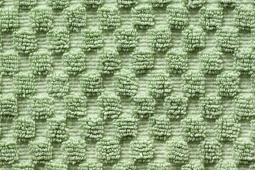 Macro shot of soft green towel with square pattern, green texture and background.