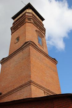 old fire tower on a background of blue sky