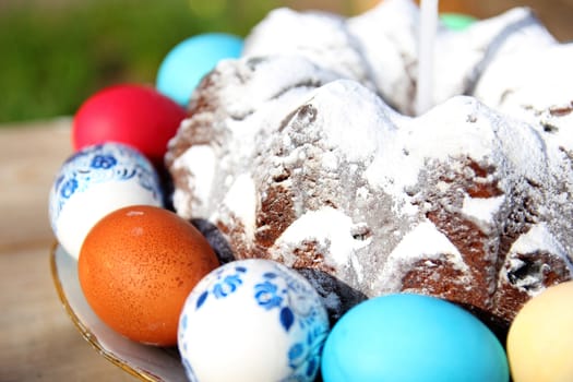 Easter cake with colored eggs on a plate