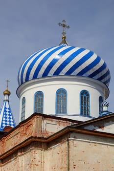 dome of the old church with crosses on sky background