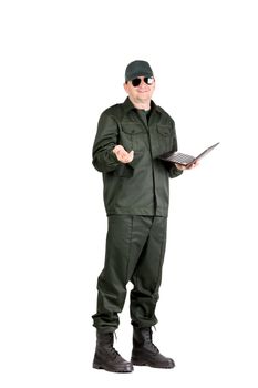 Man in workwear stands with notebook. Isolated on a white background.