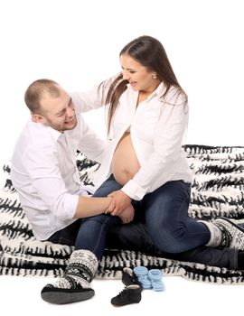 Man and pregnant woman on blanket. Isolated on a white background.