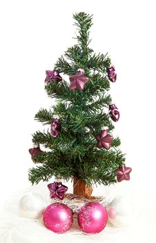 plastic christmas tree with purple stars and pink balls  isolated on white background