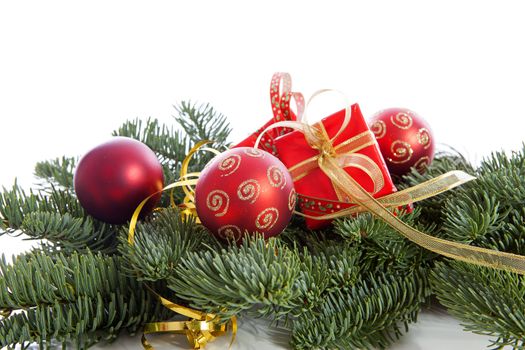 Red Christmas decoration on pine tree over white background