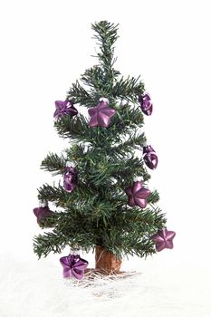 plastic christmas tree with purple stars isolated on white background