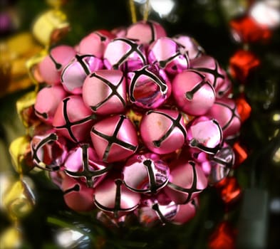 Magenta Bells Ornament Hangs on a Christmas Tree