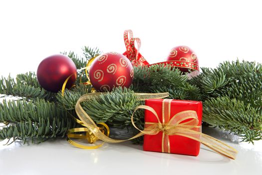 Red Christmas decoration on pine tree over white background