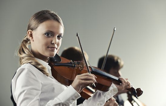  Musicians in concert, beautiful female violinist on foreground