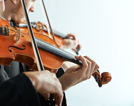 Violinist playing at the concert, hands close up