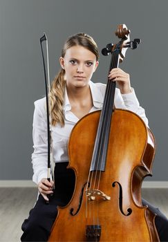 Portrait of a beautiful young woman cellist