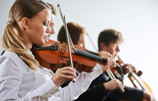  Musicians in concert, beautiful female violinist on foreground