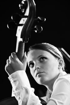 Young beautiful woman playing cello