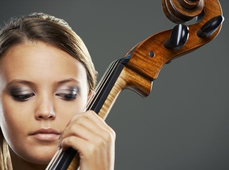 Close up portrait of a blond woman playing cello