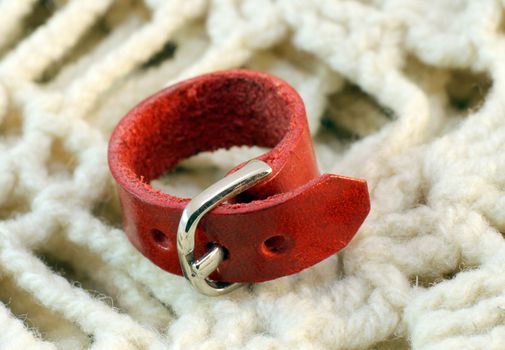 origina redl leather handmade ring on knitted background