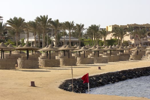 Palm trees and buildings in Egypt with sea and beach in the background 