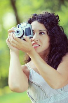 Portrait of an attractive young woman taking a photograph 