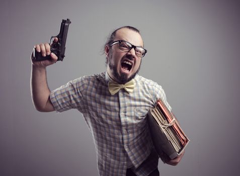 Office worker shouting with a gun on grey background