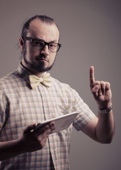 Portrait of man with a digital tablet pointing at copy space