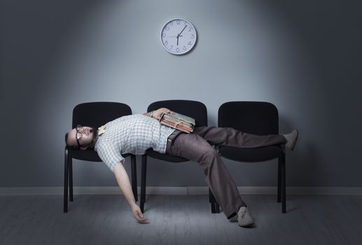 Man sleeps in a waiting room chairs