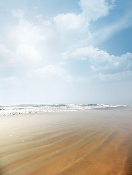 Vertical photo of the summer beach with rippled sand. Vibrant colors