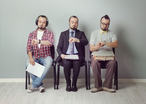 Conceptual image of three men  waiting for an interview 