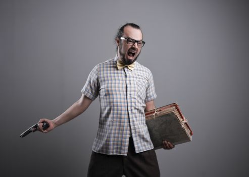 Office worker shouting with a gun on grey background