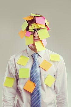 Office worker with post-its all over his face