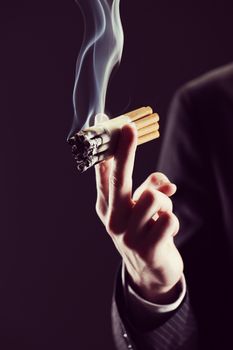 Cropped view of  young man smoking many cigarettes