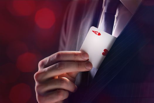The Magician with ace card hidden under the jacket