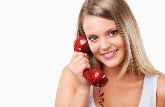 Portrait of a young woman talking on the telephone, smiling 