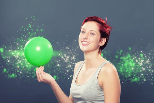 happy redhead woman with a green balloon