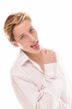 blonde woman licking a red lollipop on white background