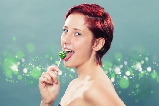 redhead woman licking a green lollipop