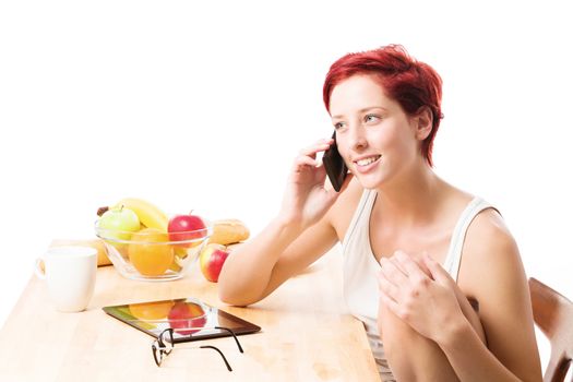 redhead woman has phone call at breakfast on white background