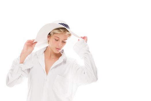 blonde young woman with a sun hat looking down on white background
