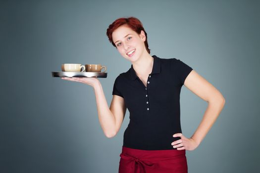 young happy redhead waitress serving coffee with a tray