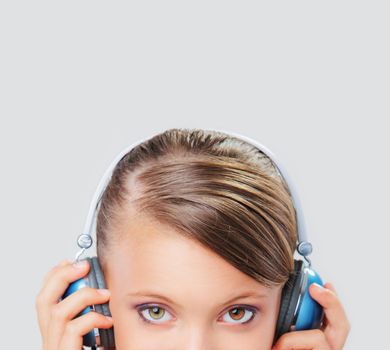 Close up of a young woman listening to music on her headphones