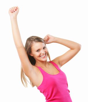 An ecstatic young woman shakes her fists in the air, isolated on white.
