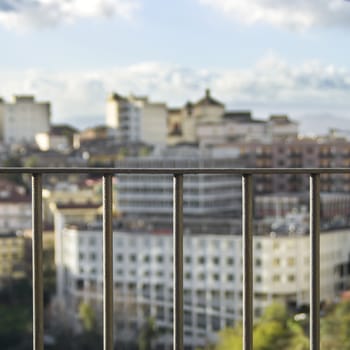 CITY IN THE BACKGROUND, VIEW THROUGH
A RAILING IN THE SPOTLIGHT