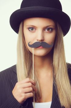 Blonde girl with mustache looking at camera