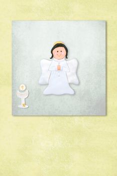 Cute Angel celebrating first communion invitation card, Background with copy space.